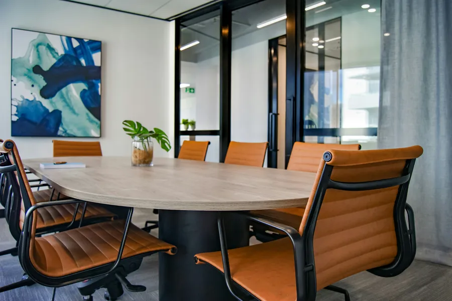 Clean, modern office meeting room with a living green wall, cleaned by North Point Cleaning